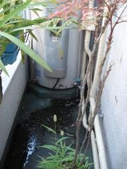 こちらが古い電気温水器です。天気は晴れ・・・なのに、下の水漏れに注目。そろそろ限界が来ているようです。